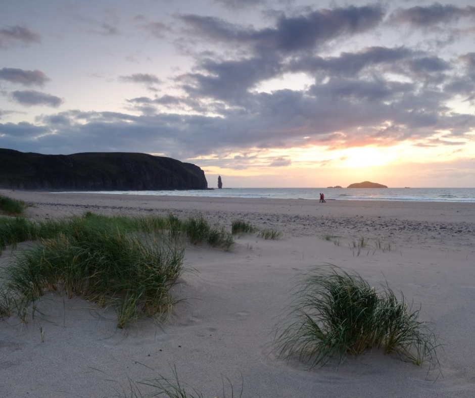 andwood Bay with a sandy beach and sea stack in the distance